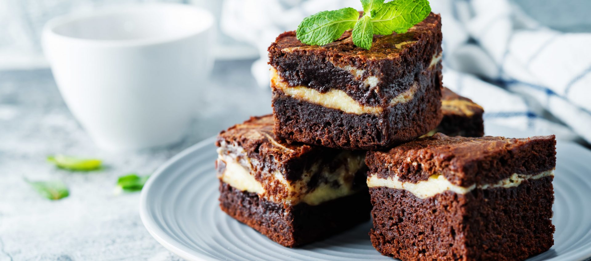 Cream cheese chocolate brownie with mint leaves